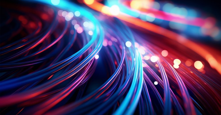 Imagem de linhas luminosas que remetem a cabos de fibra óptica ou trilhas de circuitos de dados